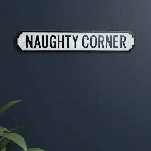 Decorative sign with 'NAUGHTY CORNER' text on a dark background