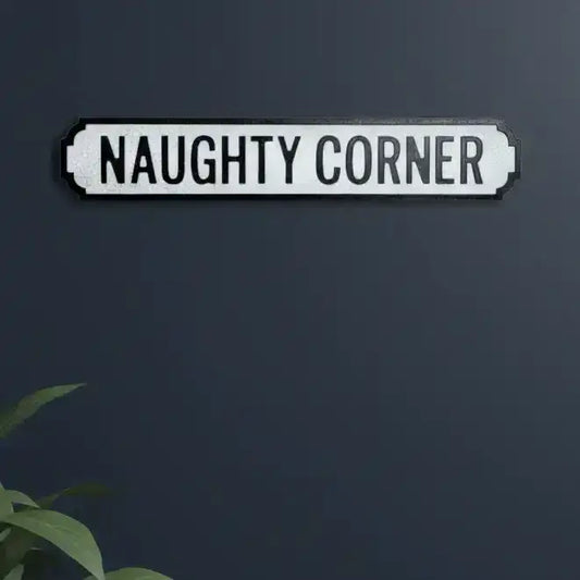 Decorative sign with 'NAUGHTY CORNER' text on a dark background