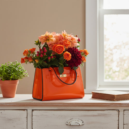 Orange handbag filled with flowers on a white background