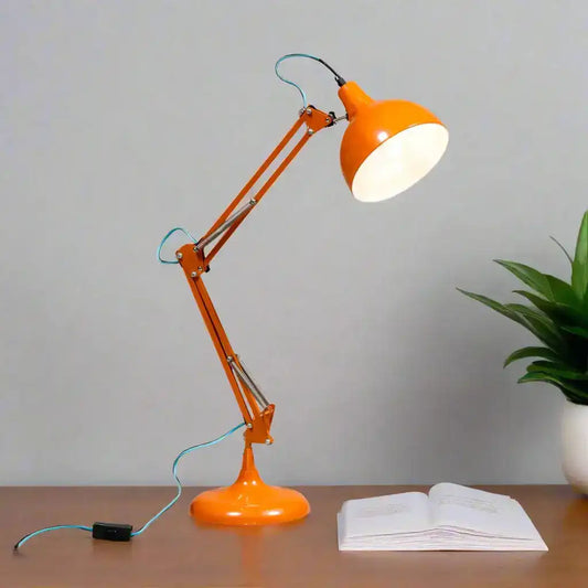 Orange desk lamp with a white light bulb on a white background