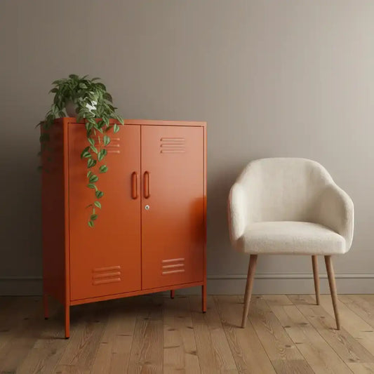 Orange cabinet with a plant next to a beige chair in a room with a wooden floor and gray walls.