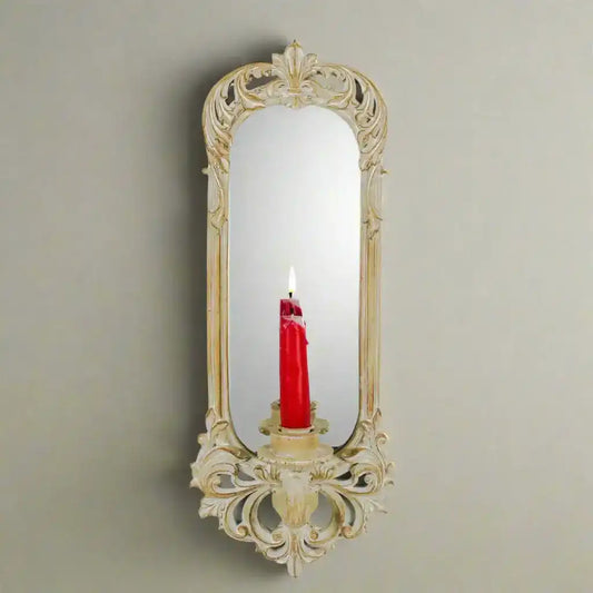 Decorative wall mirror with a candle holder on a white background