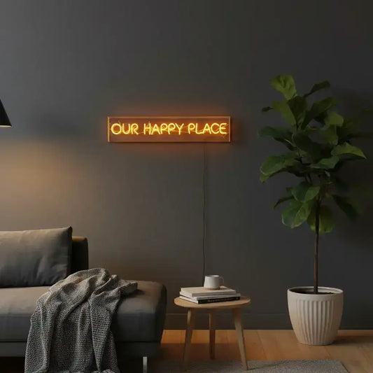 Neon sign with 'OUR HAPPY PLACE' text on a black background