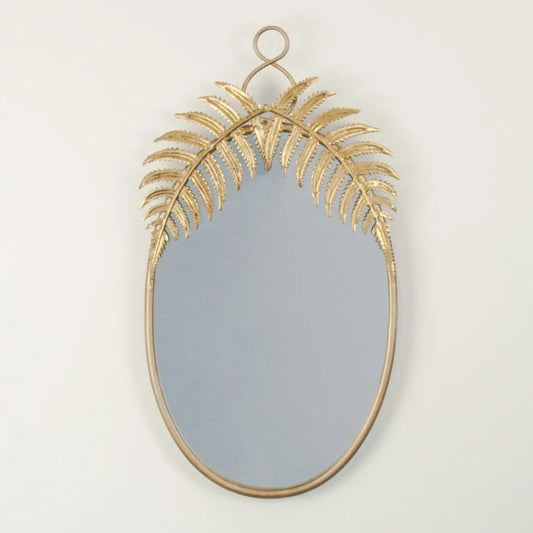 Decorative wall mirror with gold leaf design on a plain background