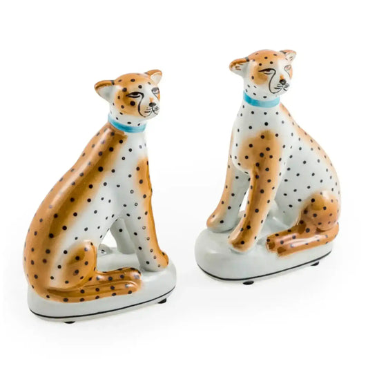 Two ceramic cheetah figurines on a white background
