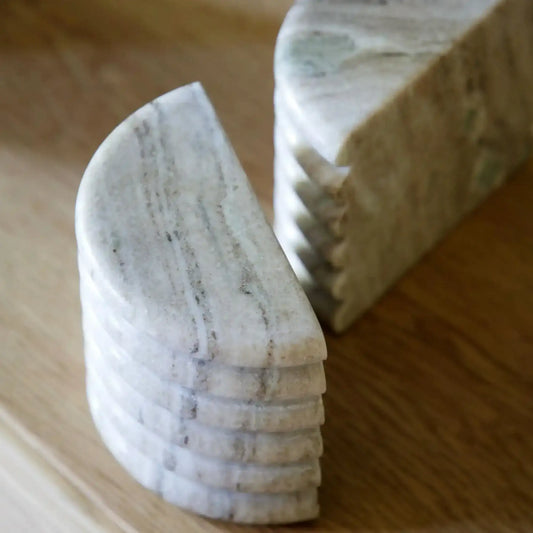 Marble-like stone coasters on a wooden surface