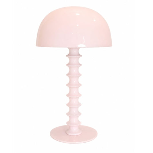 Pink table lamp with a ribbed base on a white background