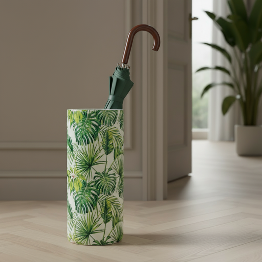 Tall cylindrical vase with green leaf pattern on a wooden floor