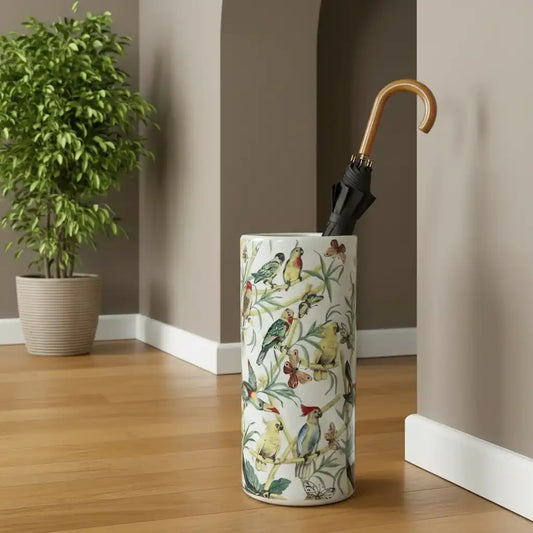 Umbrella stand with bird design next to a plant indoors