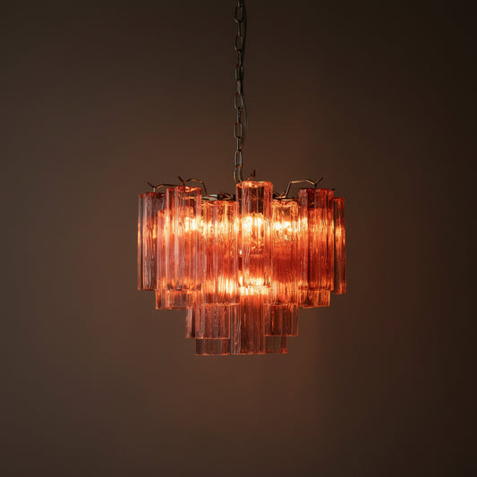Chandelier with pink glass panels on a dark background