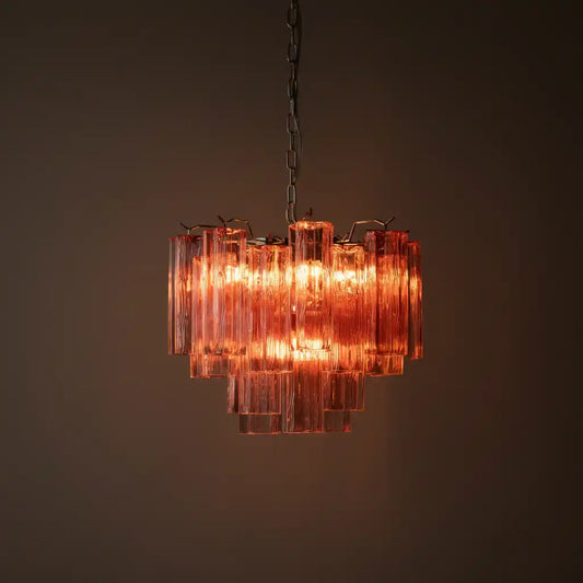 Chandelier with pink glass panels on a dark background