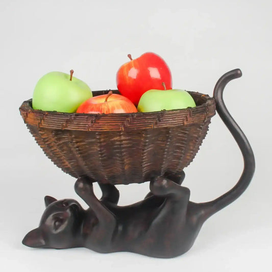 Decorative cat-shaped fruit bowl with apples on a white background