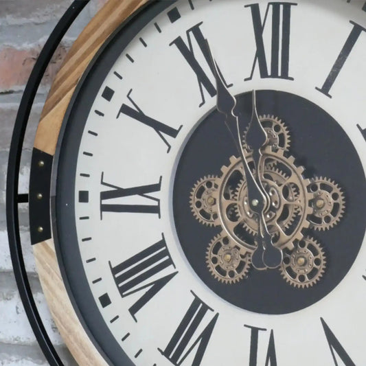 Wall clock with mechanical gear design and Roman numerals on a white face.