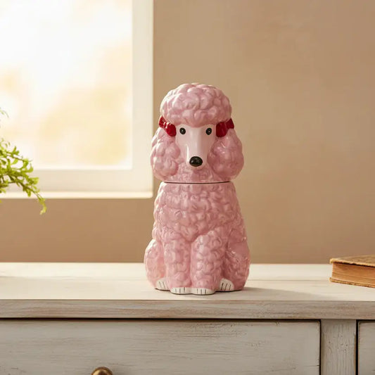 Pink poodle-shaped cookie jar on a wooden surface with a neutral background