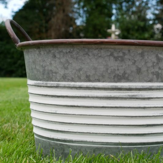 Metal basin on grass with blurred background