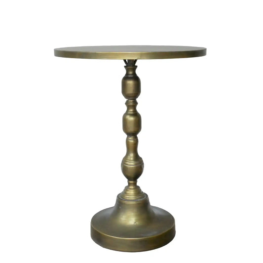 Round brass side table on a white background