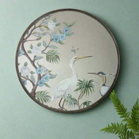 Decorative mirror with bird and floral design on a white background