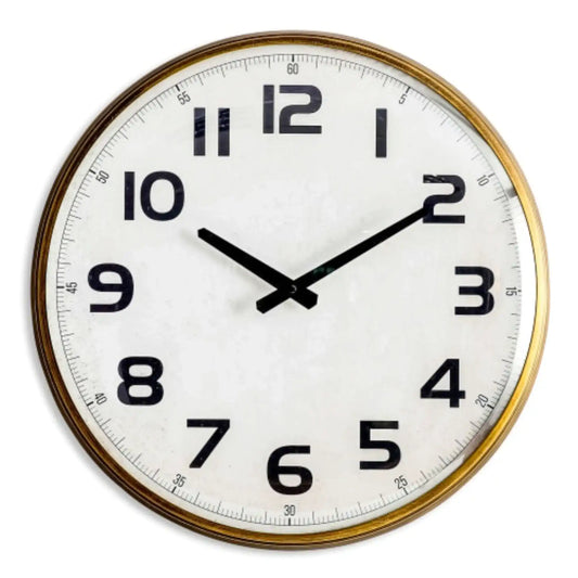 Round wall clock with gold frame and white face on a white background