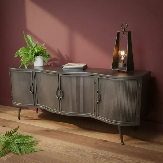 Dark wood sideboard with decorative items against a gray wall