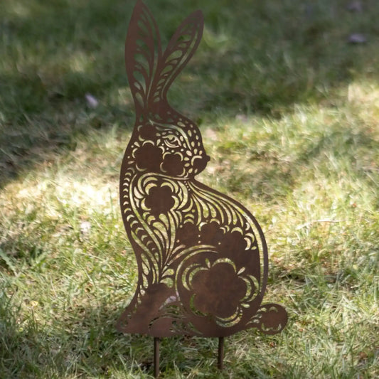 Decorative metal rabbit sculpture on grass