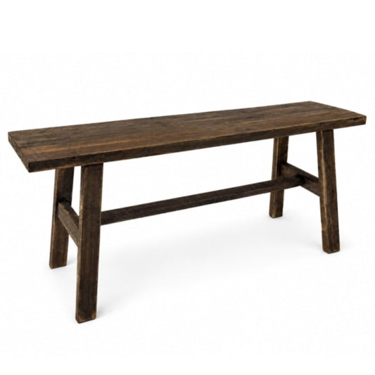 A rustic dark brown wooden bench with a thick plank seat and trestle-style legs, shown on a plain white background.
