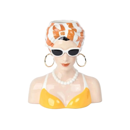 Decorative bust of a woman wearing sunglasses, a yellow swimsuit, and a striped headscarf on a white background.