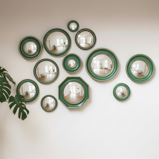 Wall with decorative mirrors in green frames and a plant on the left.