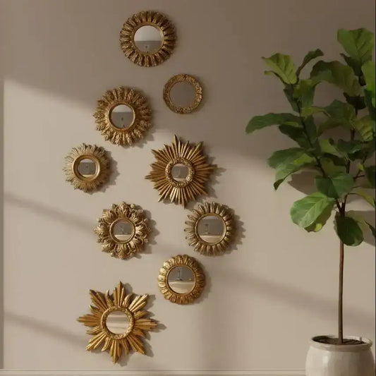 Decorative gold mirrors on a wall with a potted plant in the corner