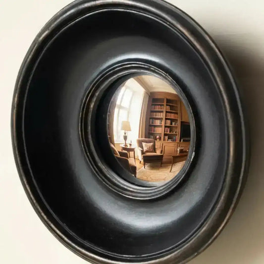 Round black metallic object with reflective interior