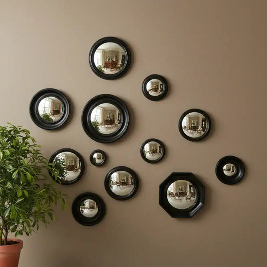 Set of round metallic mirrors in various sizes on a white background