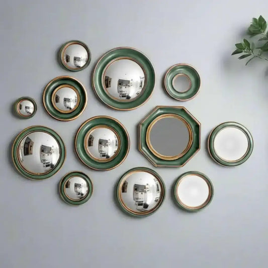 Set of ceramic plates with green and gold trim on a white background