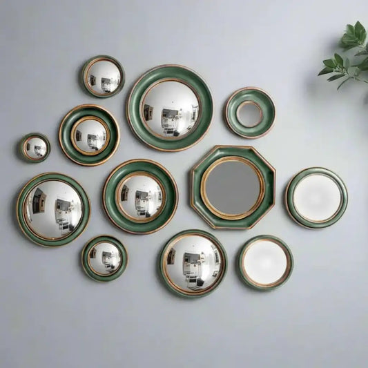 Set of ceramic plates with green and gold trim on a white background