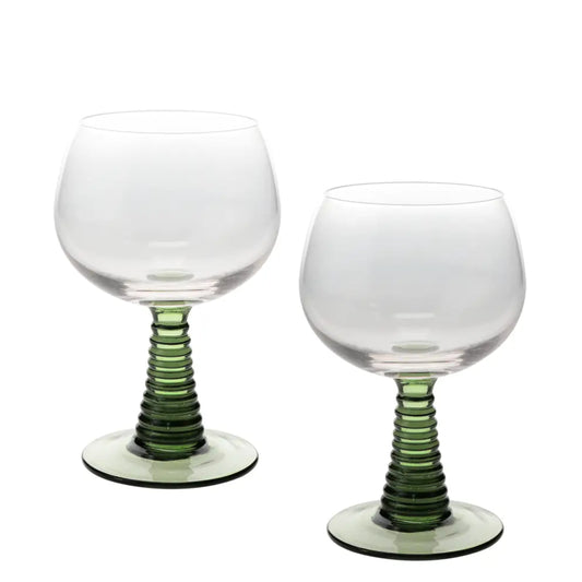Two clear stemmed glasses with ribbed green stems and circular bases, photographed on a plain white background.