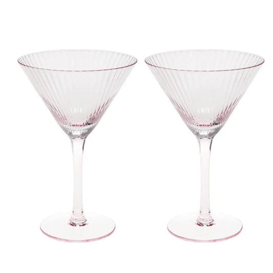 Two clear martini glasses with a delicate pink tint and vertical fluted detailing, shown side-by-side on a white background.