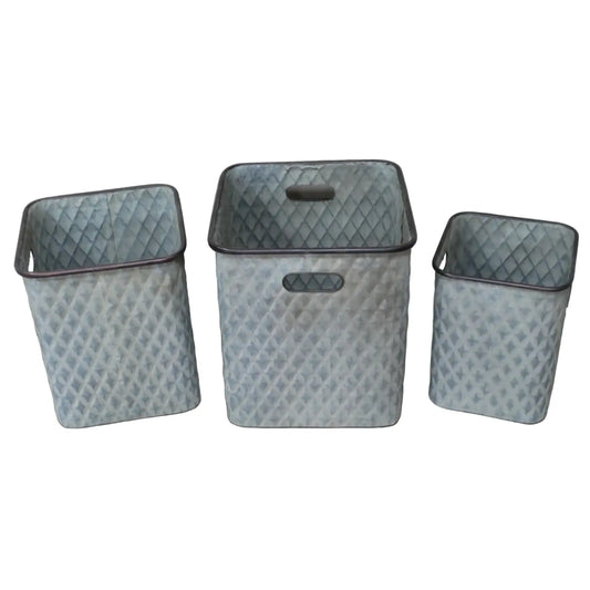 Three diamond-patterned metal baskets on a wooden surface with a neutral background