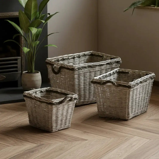 Three woven baskets of different sizes on a wooden floor.