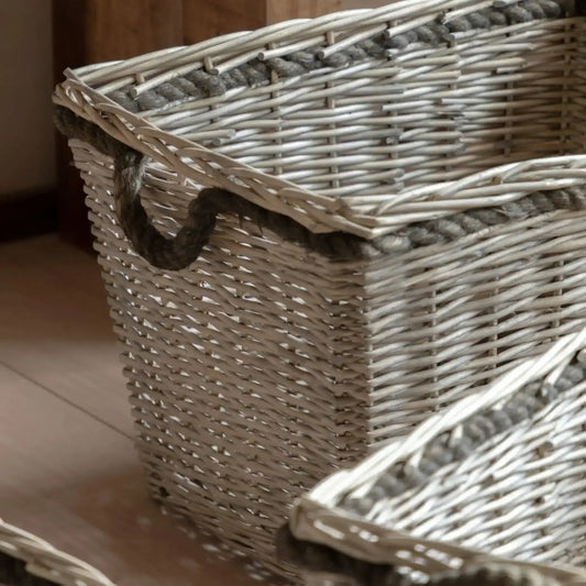 Wicker basket with a rope handle on a wooden surface