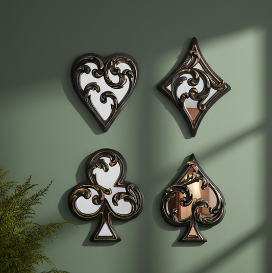 Decorative wall art pieces shaped like playing card suits on a green wall.