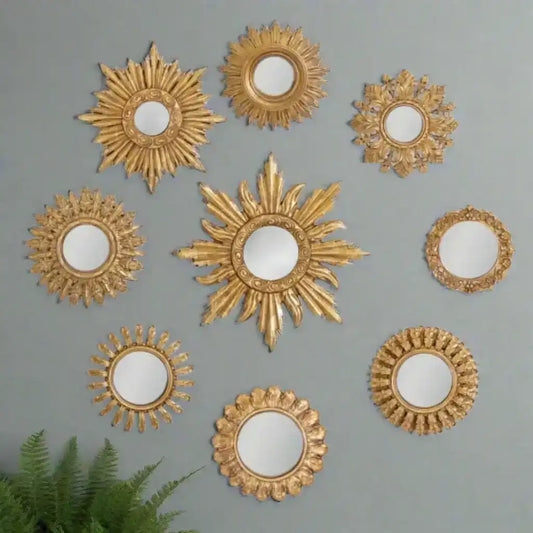 Set of gold decorative mirrors with sunburst designs on a white background