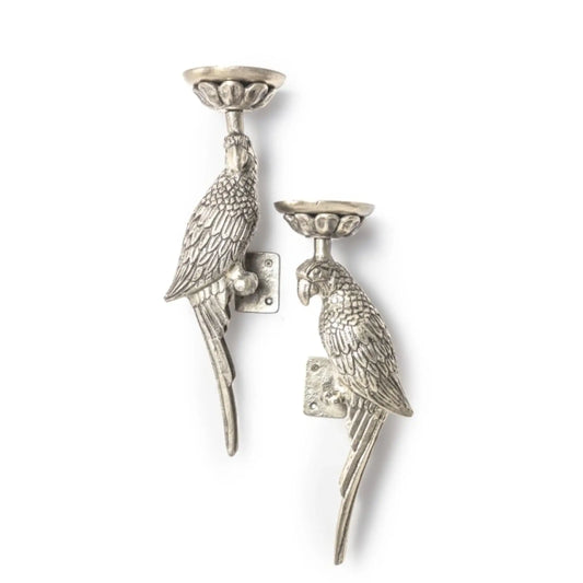 Two silver parrot-shaped candle holders on a white background