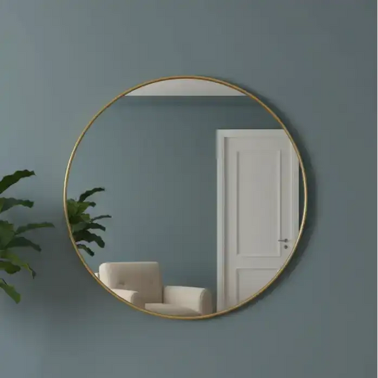 Round gold-framed mirror on a dark teal wall with a white door and plant in the reflection.
