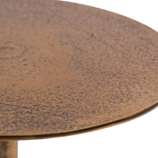 Close-up of a round metal table with a textured surface