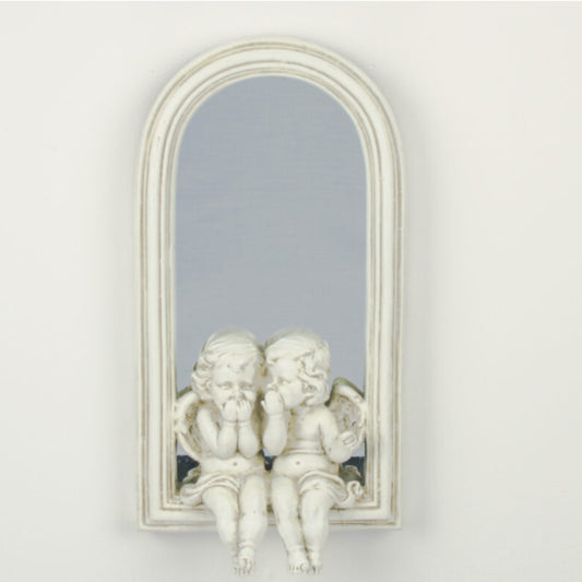 Decorative mirror with cherub sculptures on a white wall