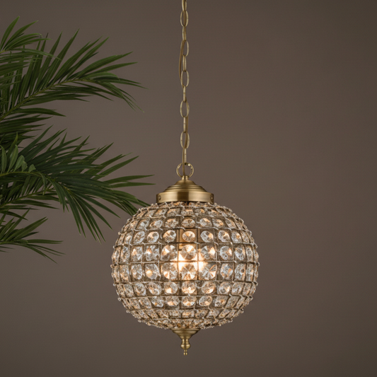 Decorative spherical lamp with crystals hanging against a neutral background