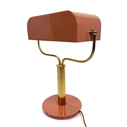 Table lamp with a brown shade and gold base on a white background
