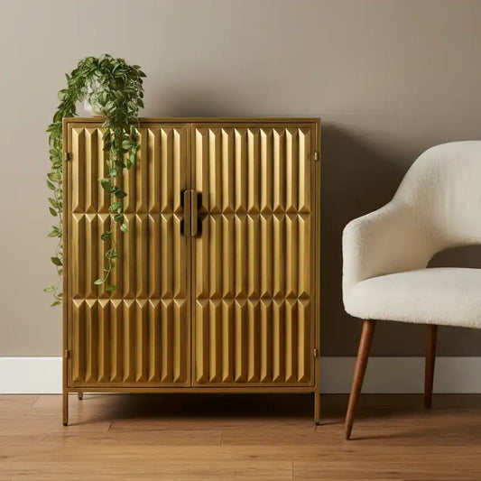 Gold cabinet with textured design in a room with a plant and chair.
