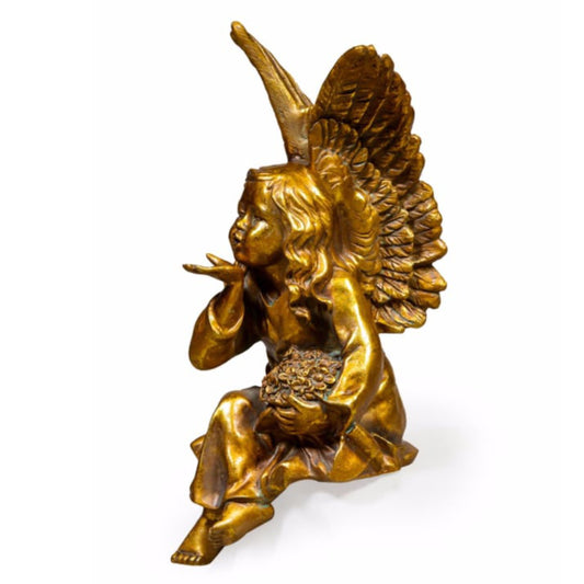 Bronze statue of an angel holding a cornucopia on a white background