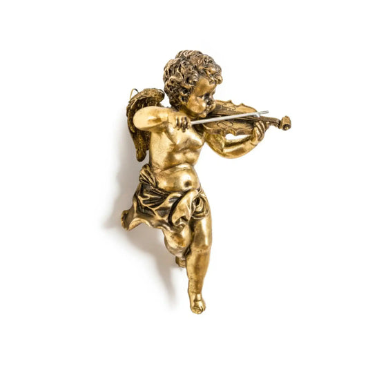 Gold statue of a winged figure playing a violin on a white background