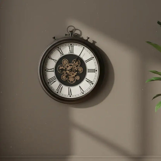 Vintage-style clock with mechanical details on a beige wall