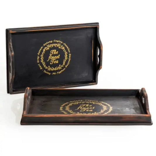 Two black trays with gold text on a white background